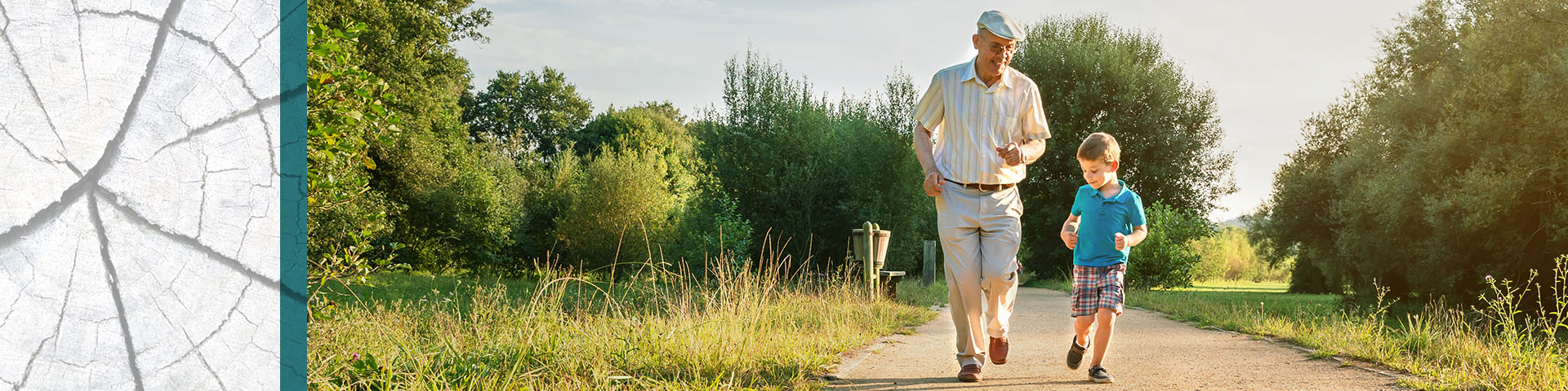 Senior and his grandson jog down an outdoor footpath