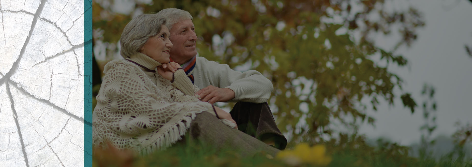 Senior couple sitting on the grass enjoying the weather