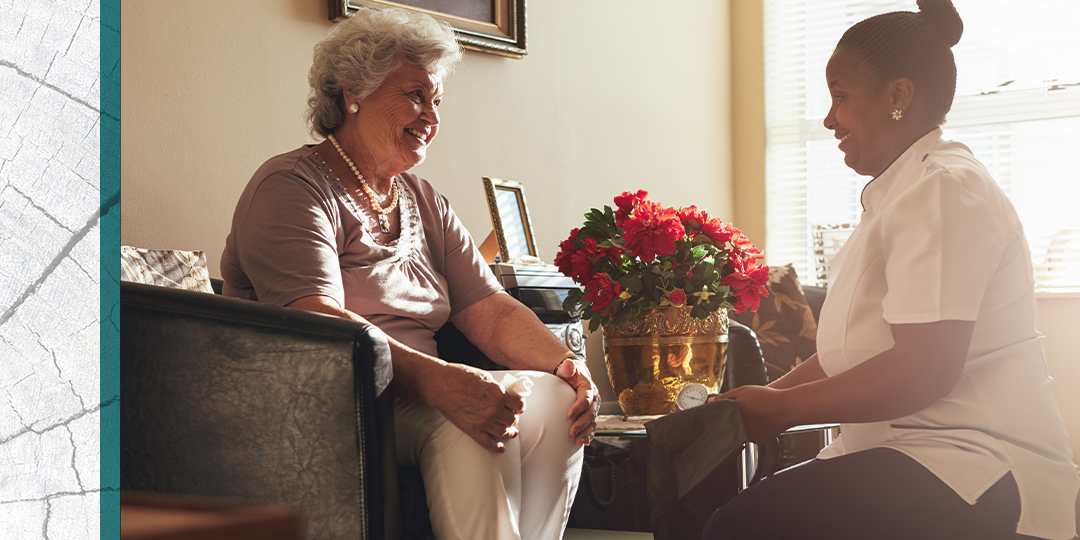 Senior resident chats with healthcare provider in her living room